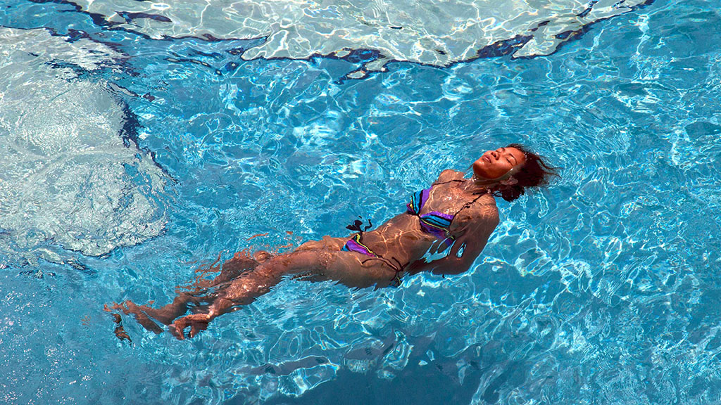 Girl in blue Pattaya hotel pool. Copyright John Borthwick